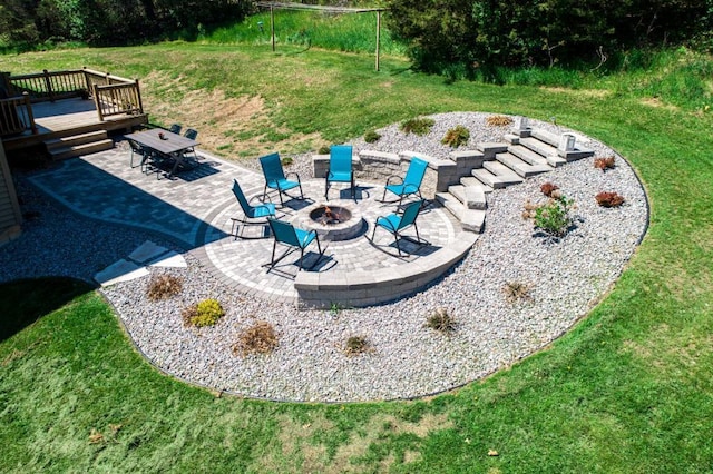 view of yard with a patio, a fire pit, and a deck