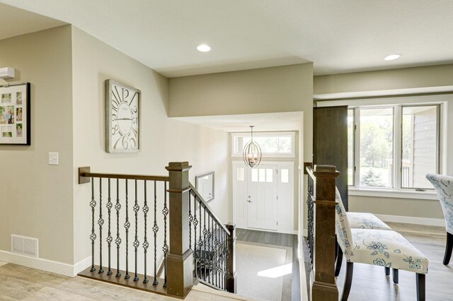 entryway with a chandelier and light hardwood / wood-style floors