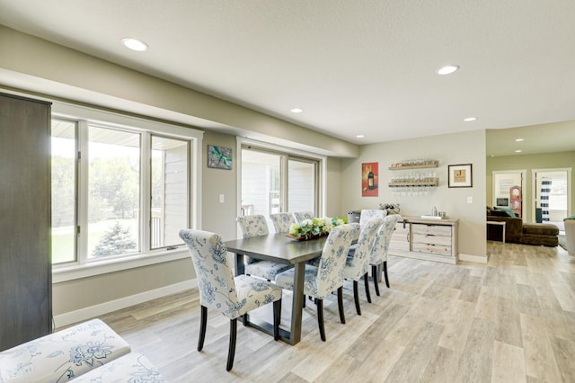 dining space featuring light wood-type flooring