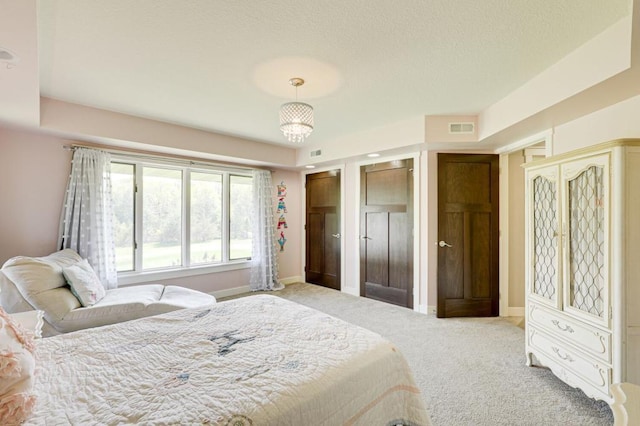 carpeted bedroom with a chandelier