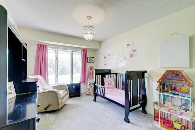 bedroom with light carpet, a chandelier, and a textured ceiling