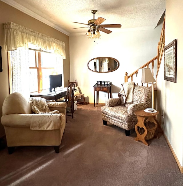 sitting room with ceiling fan, a textured ceiling, ornamental molding, and dark colored carpet