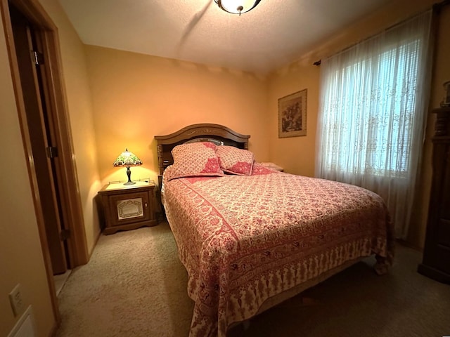 bedroom featuring light colored carpet