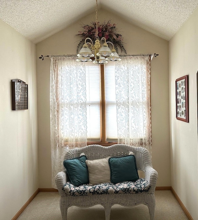 sitting room with lofted ceiling, a notable chandelier, carpet, and a textured ceiling