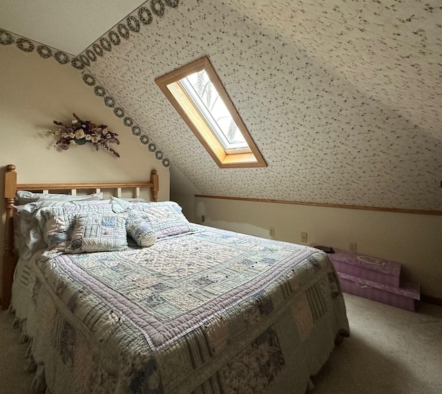 bedroom with vaulted ceiling with skylight and carpet floors