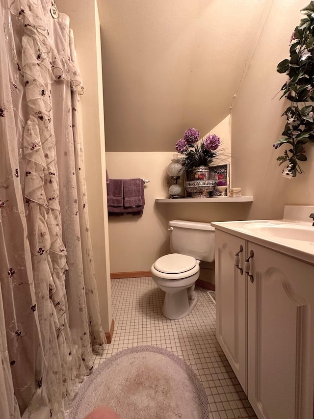 full bathroom featuring tile patterned floors, toilet, lofted ceiling, baseboards, and vanity