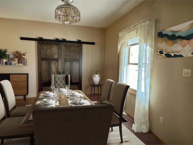 406 Rum River Dr, Princeton, MN 55371 - dining space featuring a barn door and baseboards