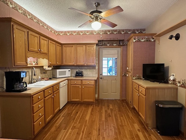 406 Rum River Dr, Princeton, MN 55371 - kitchen featuring white appliances, a sink, a textured ceiling, ceiling fan, and light countertops