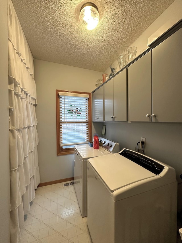406 Rum River Dr, Princeton, MN 55371 - clothes washing area with independent washer and dryer, cabinet space, a textured ceiling, light flooring, and baseboards