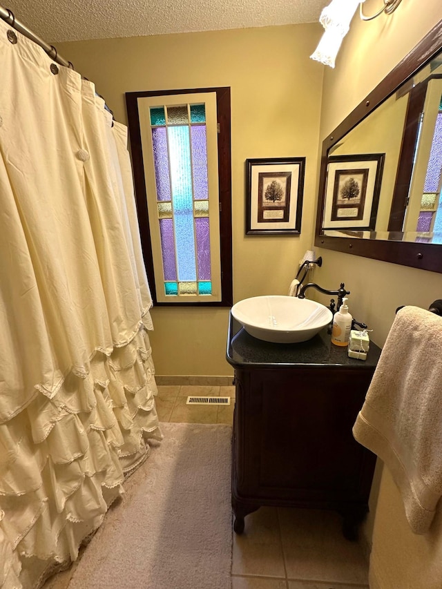 406 Rum River Dr, Princeton, MN 55371 - full bathroom with tile patterned flooring, a textured ceiling, vanity, and curtained shower