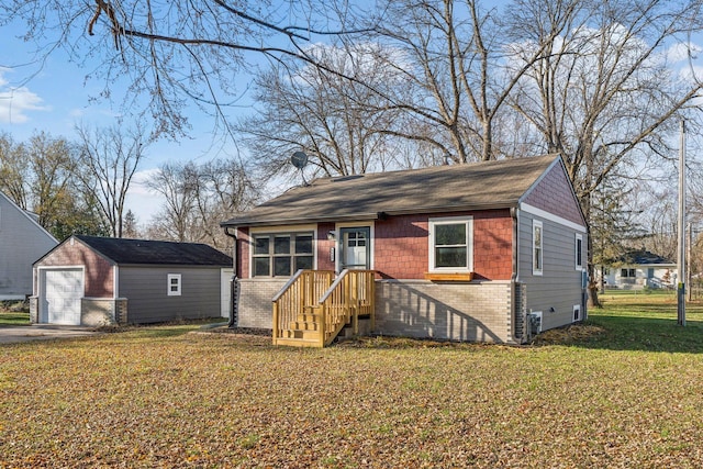 view of front of house with an outbuilding, a garage, and a front lawn