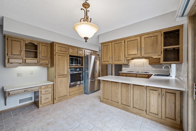 kitchen with pendant lighting, sink, appliances with stainless steel finishes, backsplash, and kitchen peninsula