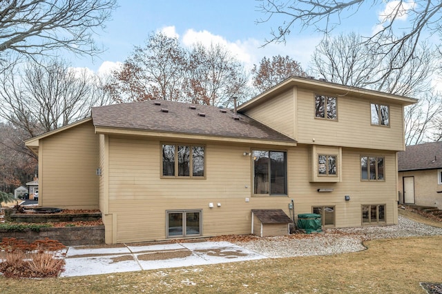 rear view of property featuring a yard