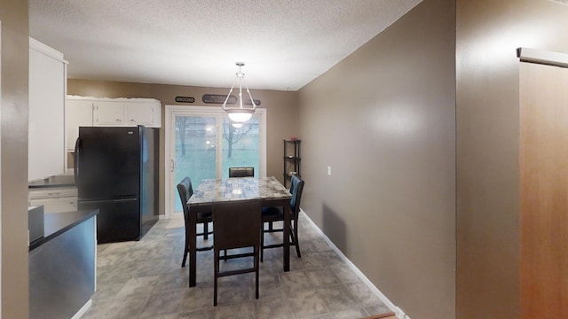 dining space with a textured ceiling