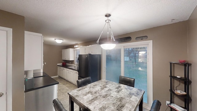 dining room featuring a textured ceiling