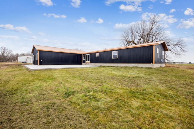 back of house with a lawn