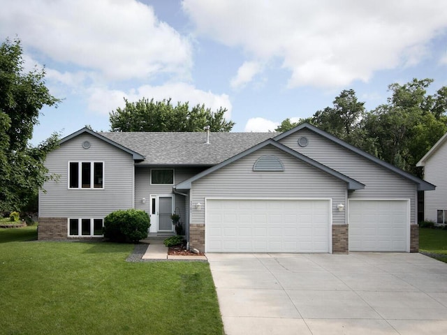 3781 Willowwood St SW, Prior Lake, MN 55372 - view of front facade with an attached garage, concrete driveway, a front yard, a shingled roof, and brick siding