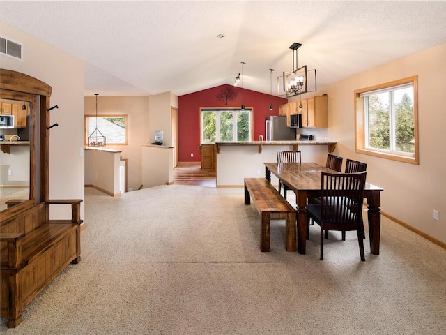 3781 Willowwood St SW, Prior Lake, MN 55372 - dining room featuring vaulted ceiling, a chandelier, and light carpet