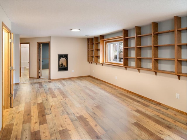 3781 Willowwood St SW, Prior Lake, MN 55372 - unfurnished living room with light wood-style floors, a fireplace, and a textured ceiling