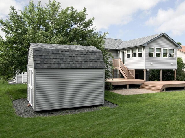 3781 Willowwood St SW, Prior Lake, MN 55372 - rear view of property featuring a shingled roof, a shed, a wooden deck, and a yard