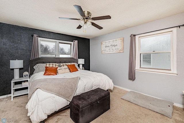 bedroom with carpet flooring, ceiling fan, and a textured ceiling