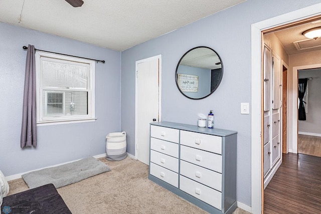 bathroom with hardwood / wood-style floors and a textured ceiling