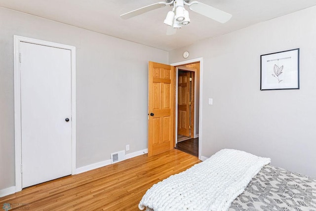 bedroom with ceiling fan and wood-type flooring