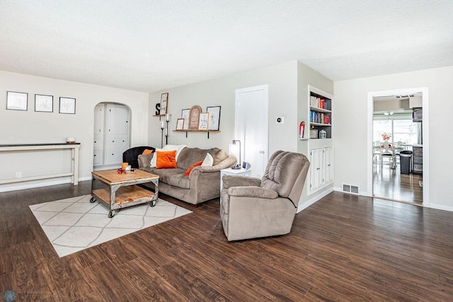 living room featuring hardwood / wood-style floors and built in features