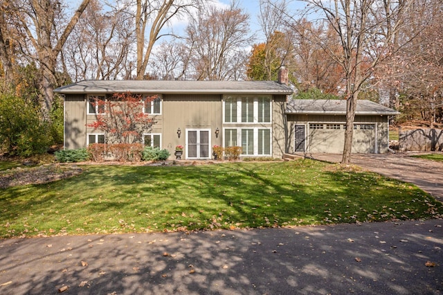 view of front of house with a garage and a front lawn