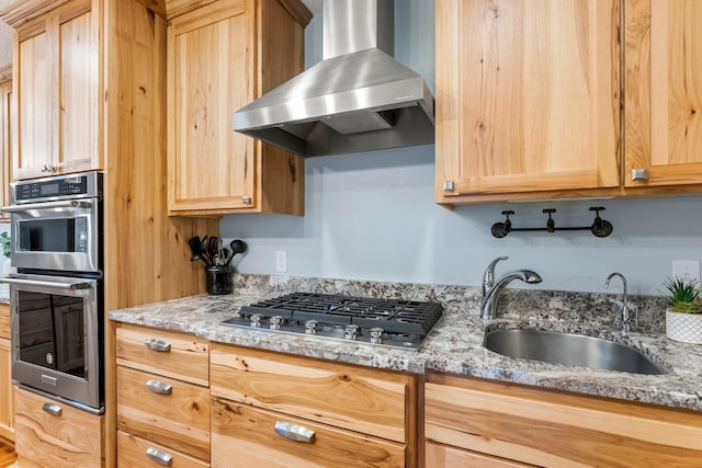 kitchen with sink, extractor fan, light brown cabinets, stainless steel appliances, and light stone countertops