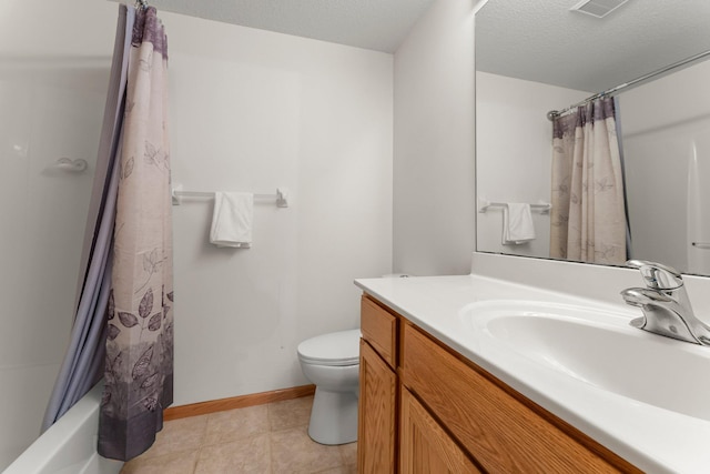 full bathroom featuring shower / tub combo with curtain, tile patterned floors, toilet, a textured ceiling, and vanity