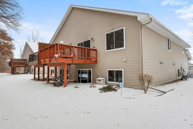 snow covered property featuring a deck