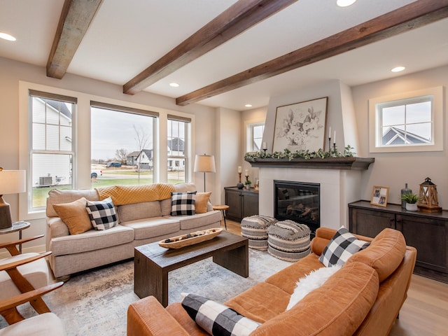 living room featuring beam ceiling and light hardwood / wood-style floors