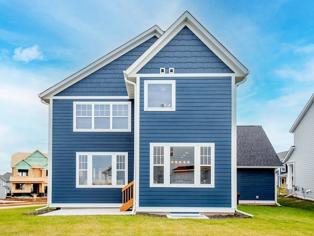 rear view of property with a patio area and a yard