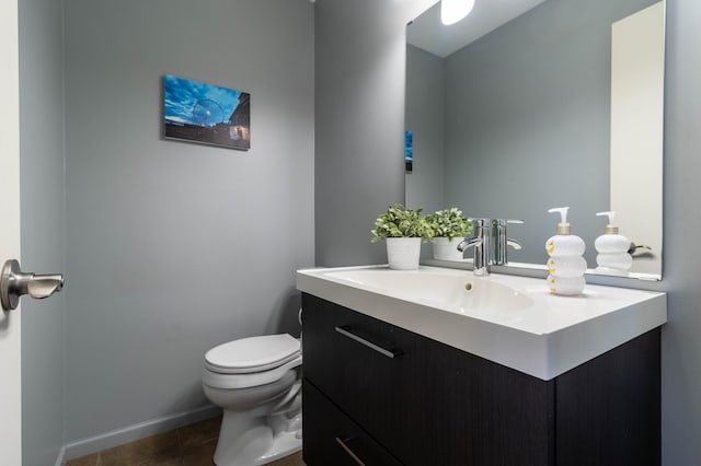 bathroom with tile patterned floors, vanity, and toilet