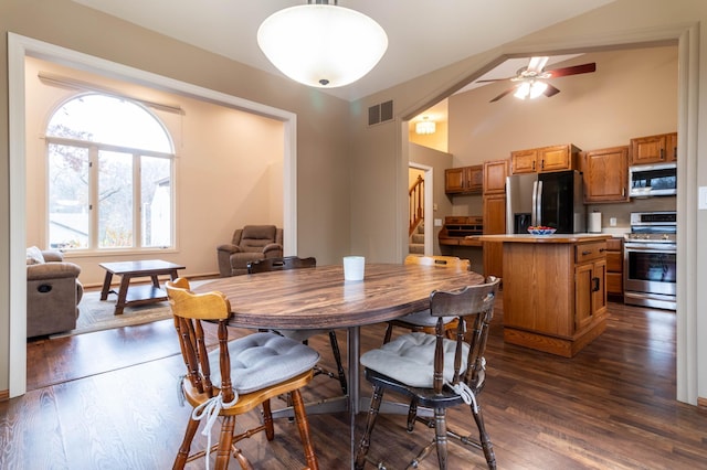 dining area with ceiling fan, dark hardwood / wood-style flooring, and lofted ceiling