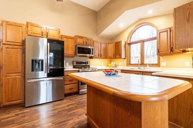 kitchen with a center island, dark hardwood / wood-style flooring, stainless steel appliances, and sink