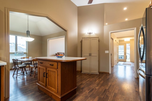 kitchen with hanging light fixtures, dark hardwood / wood-style flooring, a kitchen island, and plenty of natural light