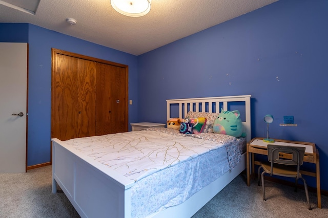 carpeted bedroom featuring a textured ceiling and a closet