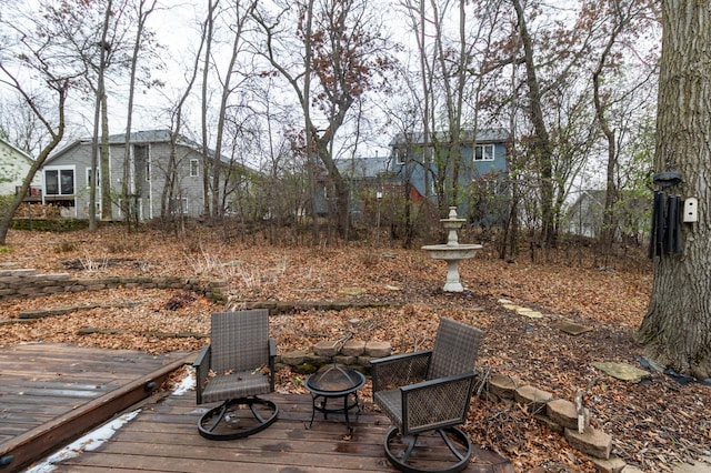 view of yard featuring a fire pit and a wooden deck