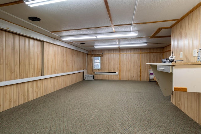 basement featuring carpet, an AC wall unit, a textured ceiling, and wooden walls