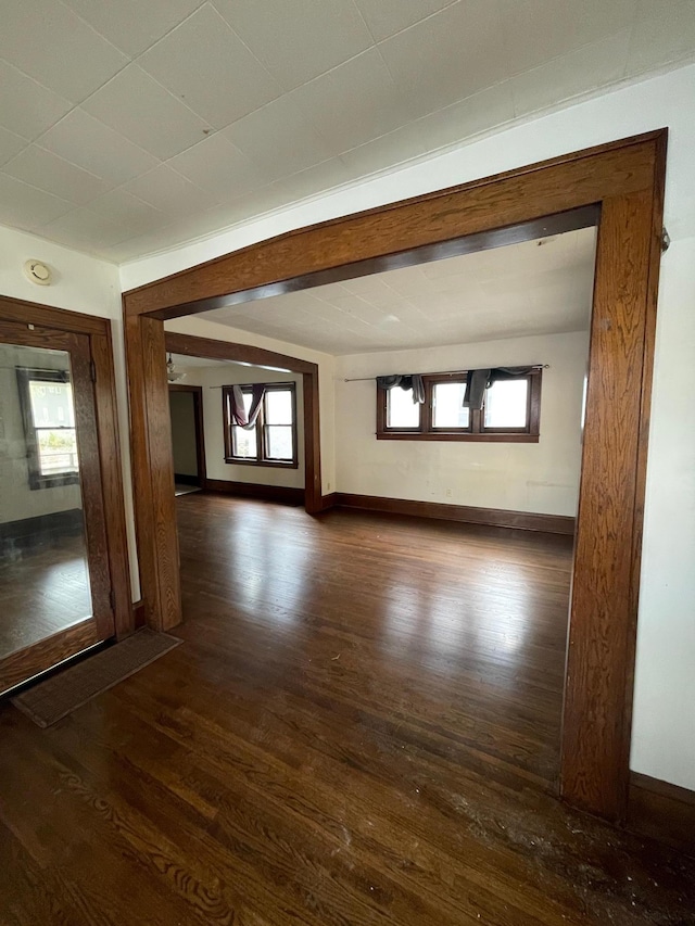 empty room with dark wood-type flooring