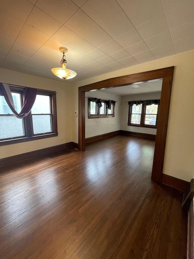 empty room with dark wood-type flooring