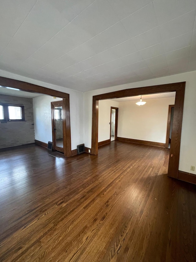 spare room with dark hardwood / wood-style floors