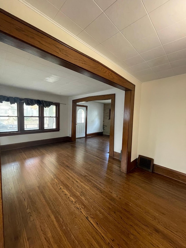 unfurnished room featuring dark wood-type flooring