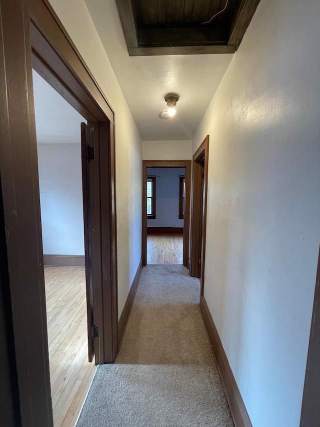 corridor with light hardwood / wood-style floors