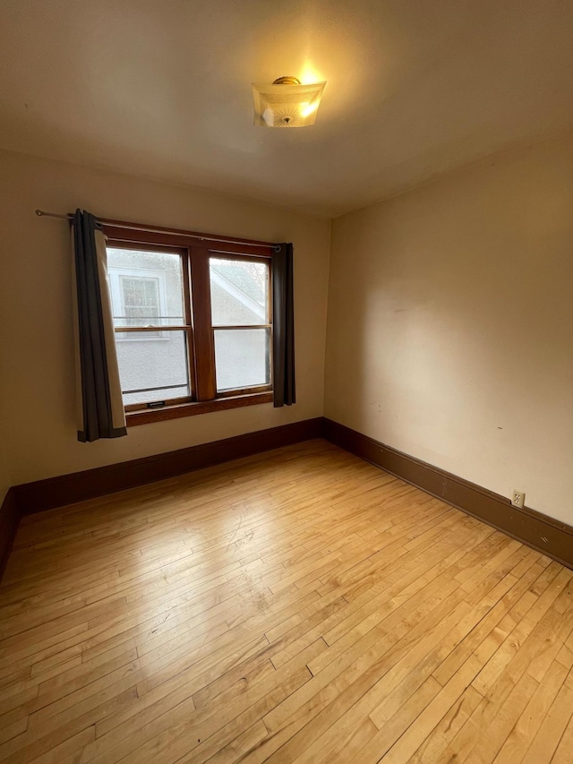 empty room with light hardwood / wood-style floors