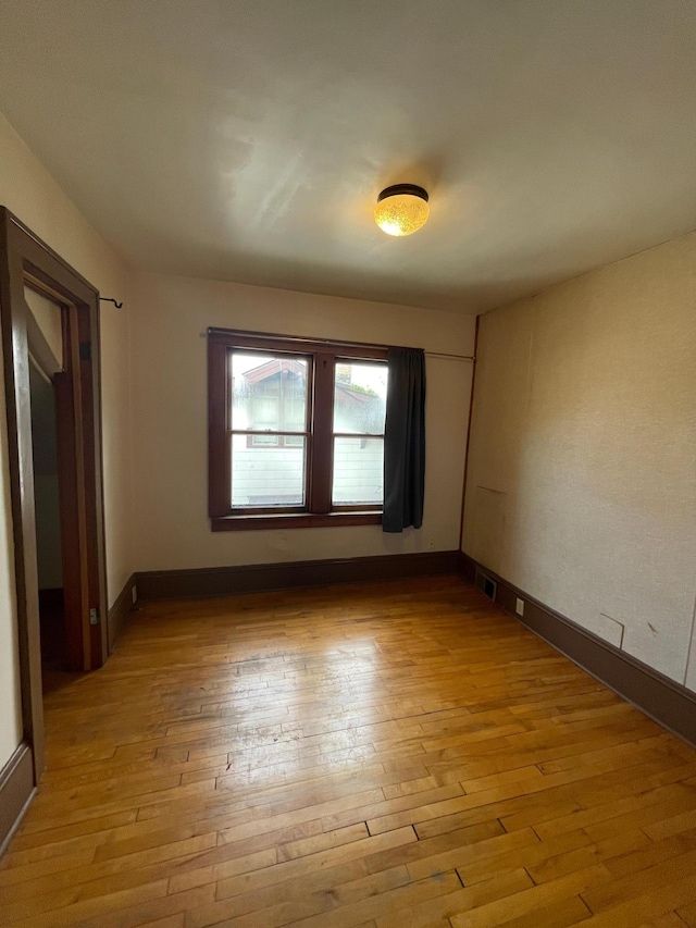 spare room featuring light wood-type flooring