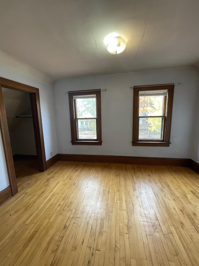 unfurnished room with a healthy amount of sunlight and light wood-type flooring