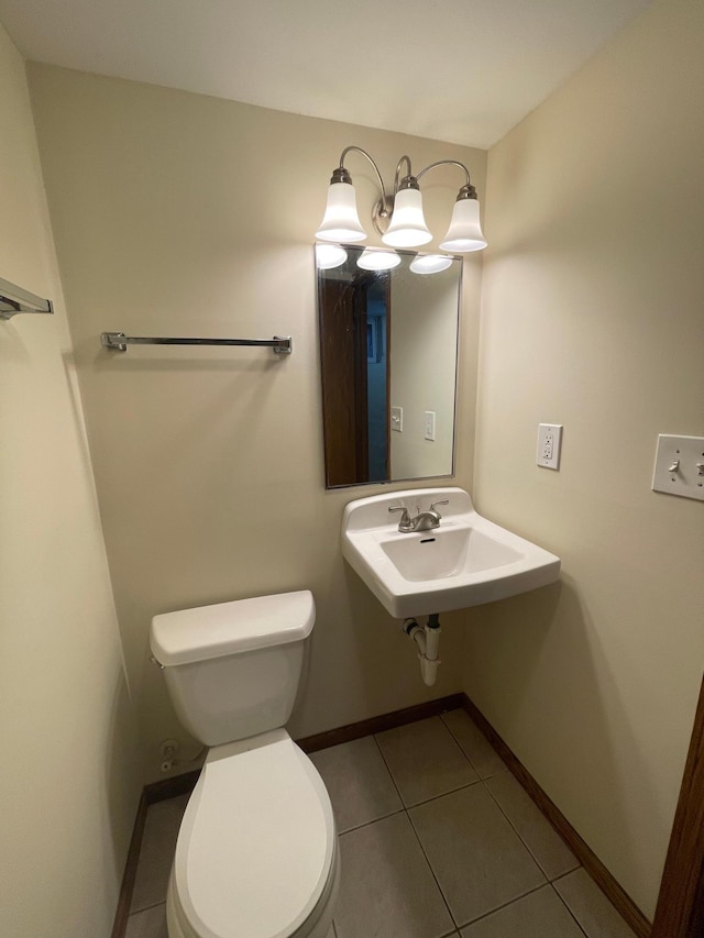 bathroom featuring tile patterned flooring, toilet, and sink